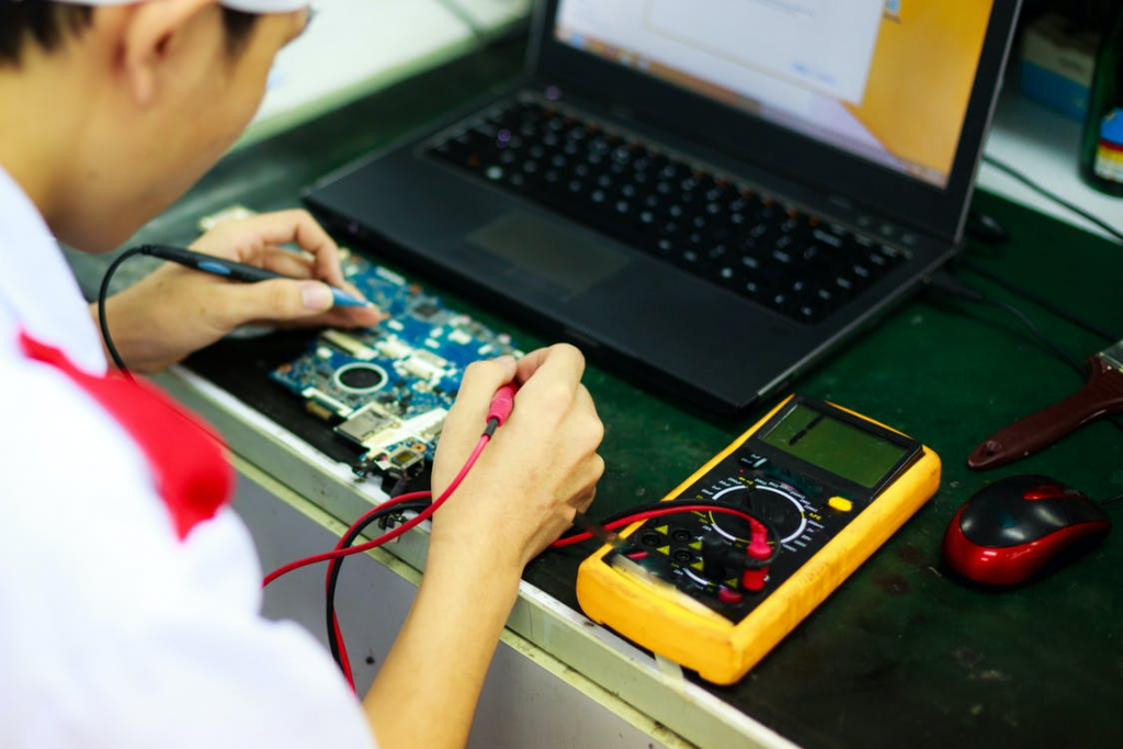 A man soldering a circuit board