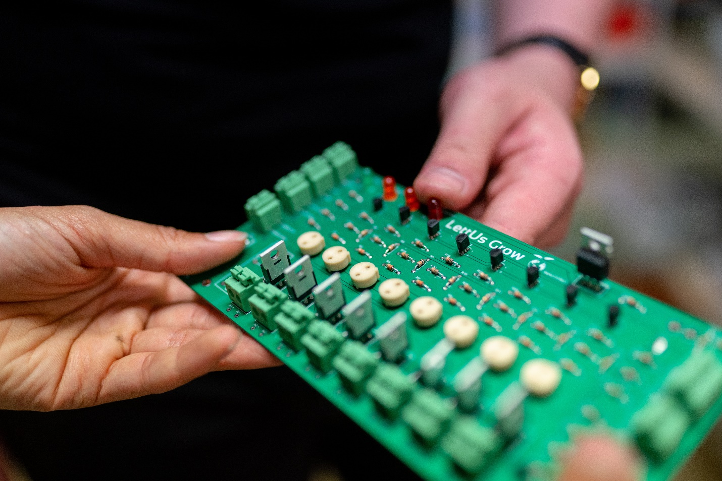 person holding circuit board